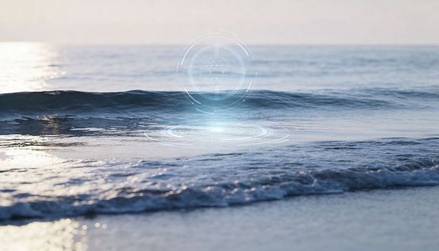 Futuristic hologram ring hovering over coastal waves at sunrise