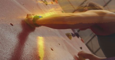 Dynamic double exposure: woman climbing at sunset