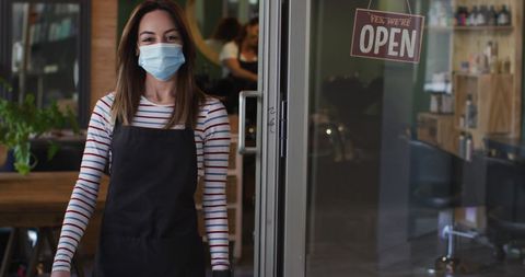 Smiling Hairdresser in Face Mask Welcoming Clients at Salon Entrance - Download Free Stock Images Pikwizard.com