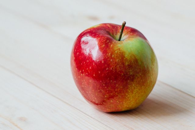 Single Fresh Red Apple on Light Wooden Surface - Download Free Stock Photos Pikwizard.com