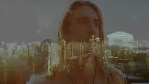 Contemplative Long-haired Person Overseeing Cemetery Scene