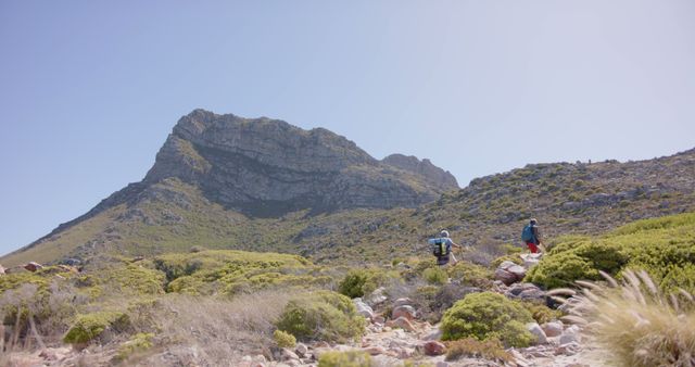 Hikers Exploring Rocky Mountain Terrain Under Blue Sky - Download Free Stock Images Pikwizard.com