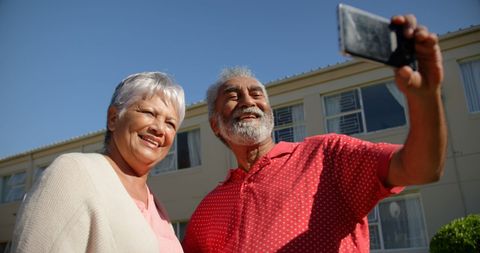 Senior Couple Taking Selfie Outdoors at Nursing Home
