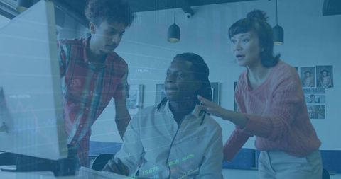 Focused Coworkers Reviewing Project on Computer in Modern Office