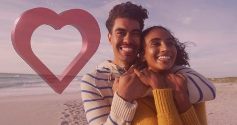 Loving couple embraces on beach with heart symbol