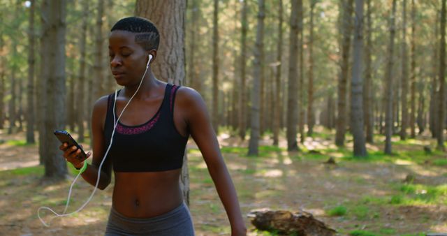 Young Woman Running in Forest Listening to Music - Download Free Stock Images Pikwizard.com