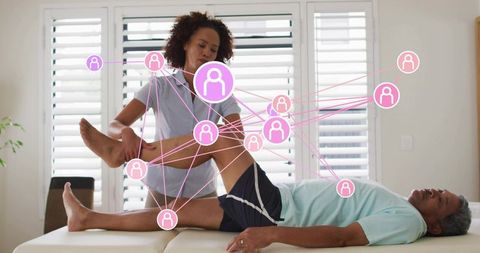 Physiotherapist stretching senior patient with digital network overlays for rehab tracking