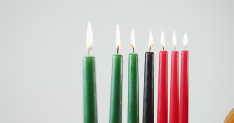 Row of Lit Colored Candles in Festive Display