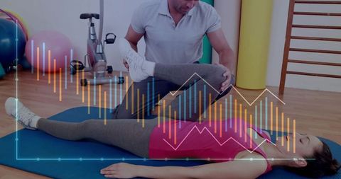 Physiotherapist assisting woman stretching knee on mat during rehabilitation session