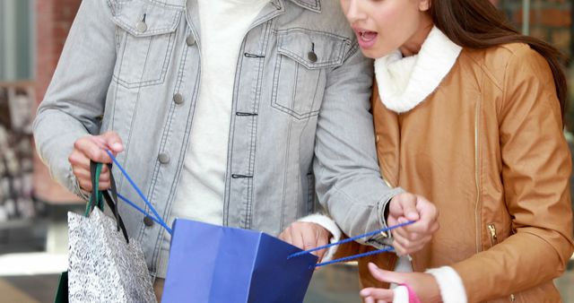 Excited Young Couple Enjoying Shopping Spree and Unpacking Bags - Download Free Stock Images Pikwizard.com