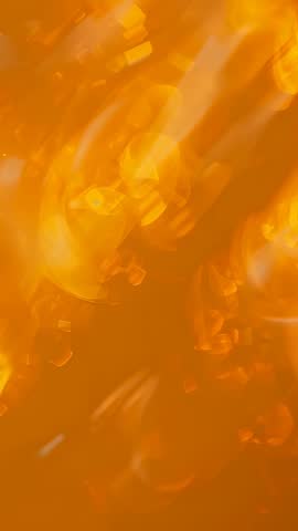Vertical abstract amber bokeh particles drifting in glowing motion for dynamic backgrounds