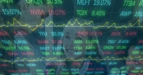Financial analysts reviewing tech stock indicators on transparent display