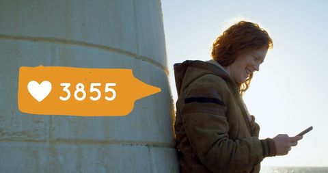 Cheerful woman gaining social media likes