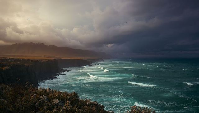 Stormy coastline with dramatic rocky cliffs and turbulent waves