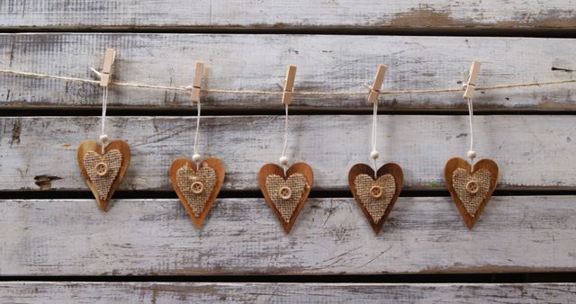 Rustic Wooden Hearts Hanging on String Against Weathered Wooden Background - Download Free Stock Images Pikwizard.com