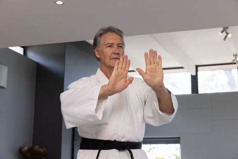 Senior male practicing martial arts techniques for fitness and focus