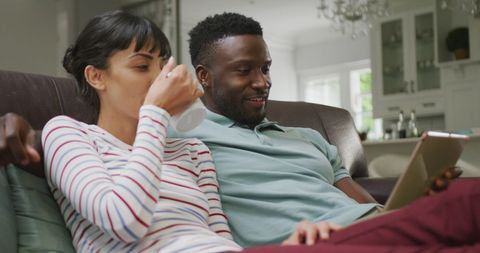 Happy Couple Relaxing at Home with Coffee and Tablet