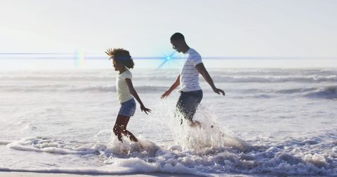 Joyful Father and Daughter Playing by the Ocean - Download Free Stock Images Pikwizard.com
