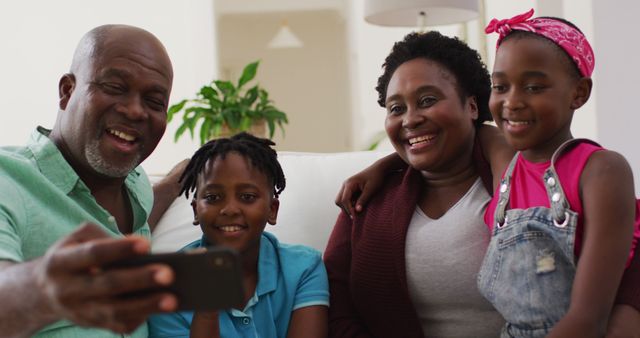 Happy African American family taking selfie on couch - Download Free Stock Images Pikwizard.com