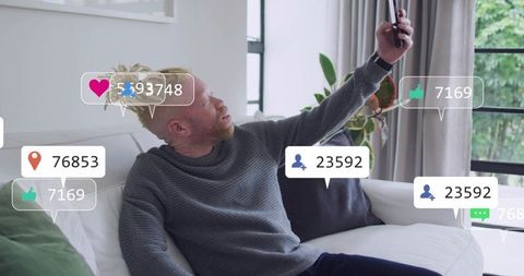 Man Taking Selfie on Sofa with Social Media Notifications and Engagement Overlays