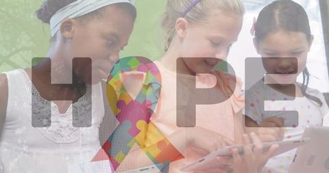Motivated girls learning with tablets and autism hope ribbon emblem