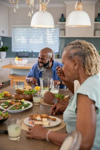 Joyful Family Enjoying Meal Together around Dining Table