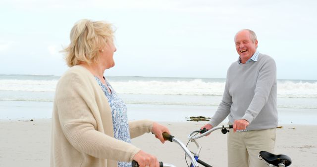 Senior couple enjoying a casual morning by the beach with their bicycles. Likely used in contexts related to health, lifestyle, aging happily, outdoor activities for seniors, and promoting active living among elderly people. Great for articles, advertisements, or campaigns focusing on senior wellness and outdoor activities.