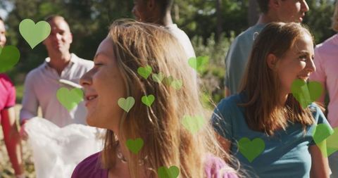 Happy Volunteers Collecting Litter in Scenic Outdoor Area