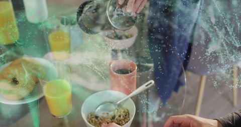 Pouring coffee from french press over cozy breakfast with cereal and orange juice
