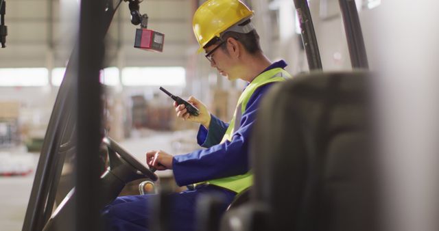 Warehouse Worker Operating Forklift with Radio Communication - Download Free Stock Images Pikwizard.com