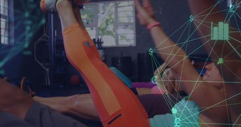 Vibrant group workout featuring orange leggings, core leg raises and digital network overlay