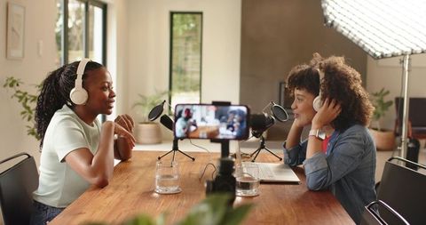 Recording intimate podcast conversation in home studio with headphones and microphones