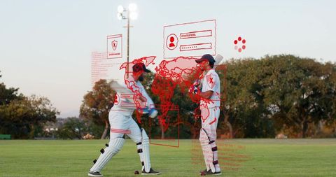 Two cricketers practicing outfield at dusk with red digital overlay indicating cyber threat