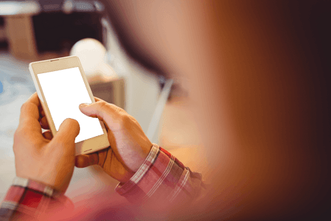 Graphic designer holding transparent screen smartphone in creative studio