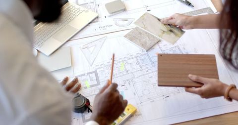 Colleagues Collaborating on Architectural Design Plans - Download Free Stock Images Pikwizard.com