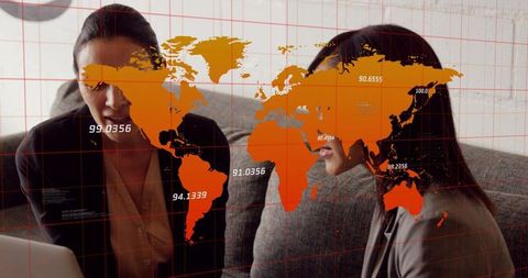 Businesswomen Collaborating Over Global Data Visualization With Orange World Map Overlay