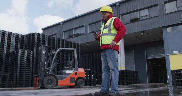 Warehouse Worker Using Smartphone for Logistics Coordination - Download Free Stock Images Pikwizard.com