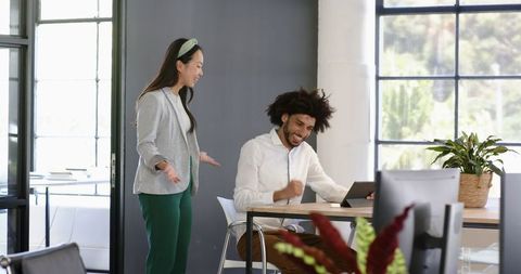 Diverse Business Team Celebrates Success in Modern Office