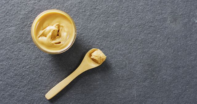 Top View of Smooth Peanut Butter with Wooden Spoon - Download Free Stock Images Pikwizard.com