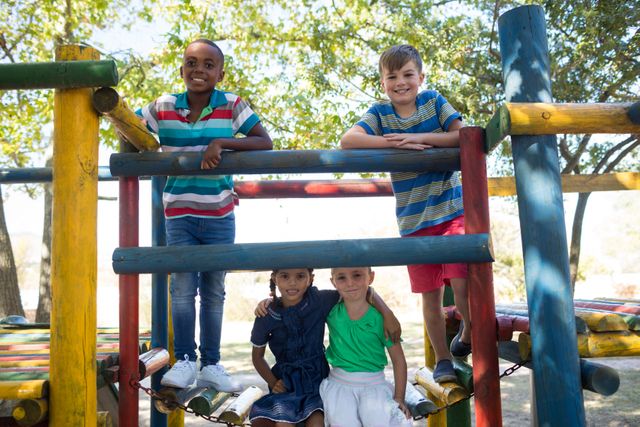 Portrait of happy friends on enjoying on jungle gym at playground