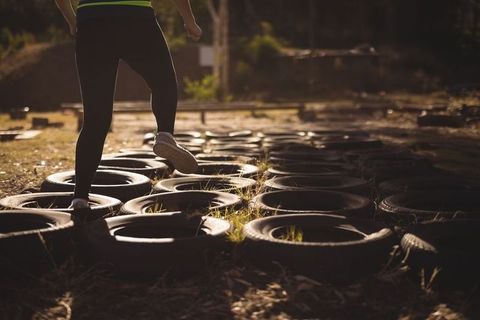 Individual Engaging in Tire Grid Endurance Exercise Outdoors