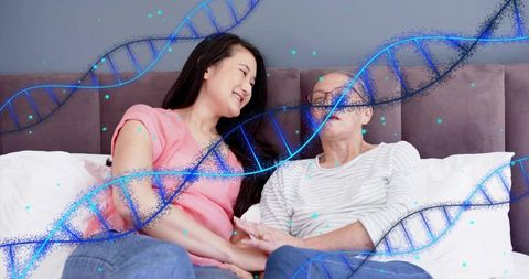 Daughter holding hands with older mother on bed with dna double helix overlay