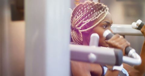 Determined Young Woman Training with Fitness Equipment