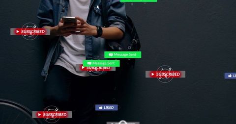 Urban man leaning against dark wall using smartphone with floating social media overlays