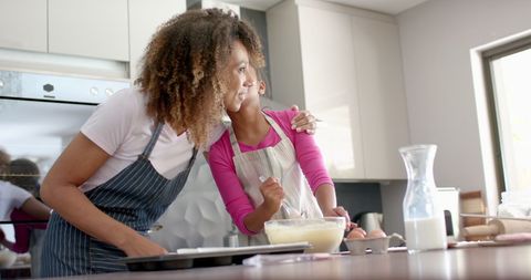 Happy Mother-Daughter Baking Session in Sunlit Kitchen - Download Free Stock Images Pikwizard.com