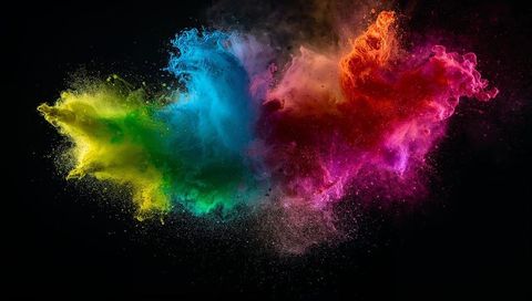 Vibrant multicolored powder explosion on dark background