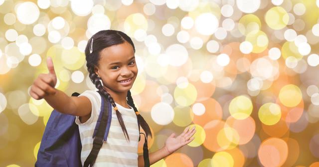 Cheerful schoolgirl showing thumbs up while smiling with bokeh background, conveying positivity and confidence. Suitable for educational materials, back-to-school campaigns, or advertisements focusing on children and their enthusiasm towards learning.