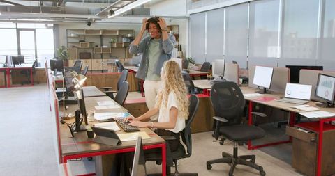 Team Members Collaborating on Project in Modern Office Environment