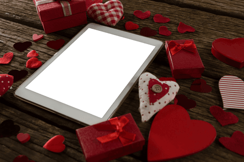 Digital Tablet with Transparent Screen Among Valentine Decorations