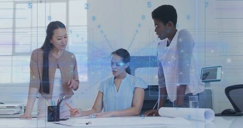 Colleagues Collaborating Over Design Plans in Modern Office